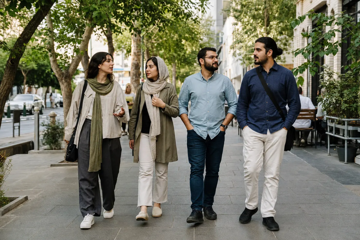 Adults wearing contemporary everyday clothing on a city street in Iran