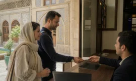 Visitors receiving tickets at the entrance desk of a historic museum in Iran