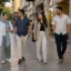 Contemporary everyday clothing on a pedestrian street in Iran, including layered outfits, trousers and a loose headscarf